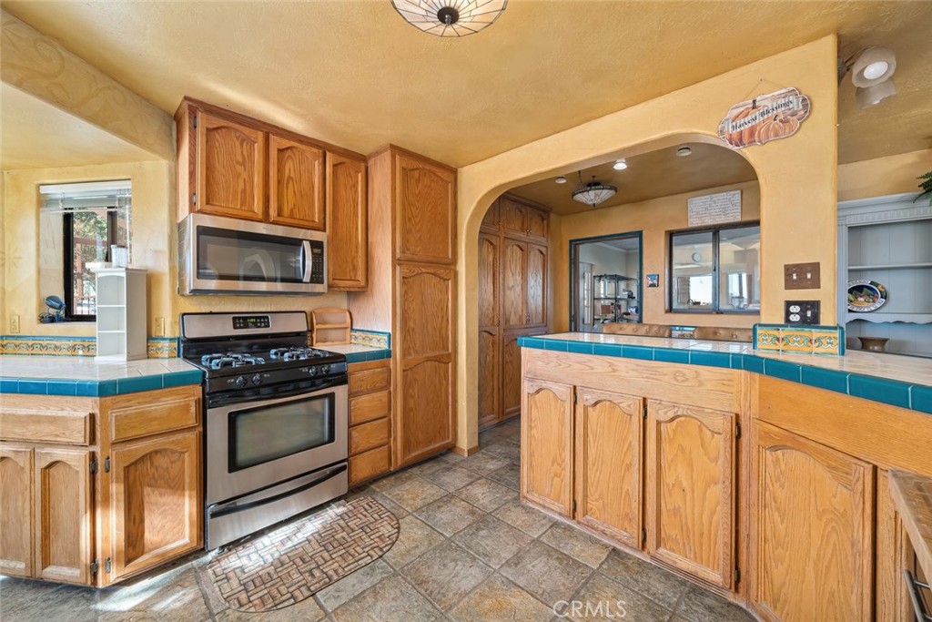 330 East Ormonde Road Arroyo Grande, CA 93420 - Photo 14 of 56 a kitchen with stainless steel appliances granite countertop a stove and a sink