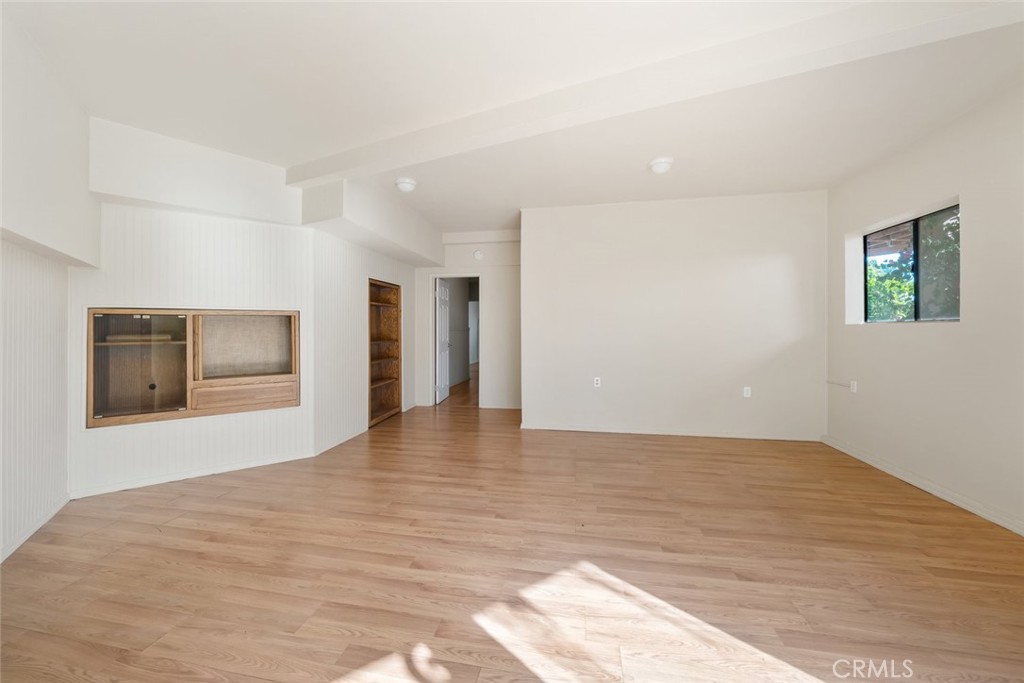 330 East Ormonde Road Arroyo Grande, CA 93420 - Photo 30 of 56 a view of an empty room with wooden floor and kitchen