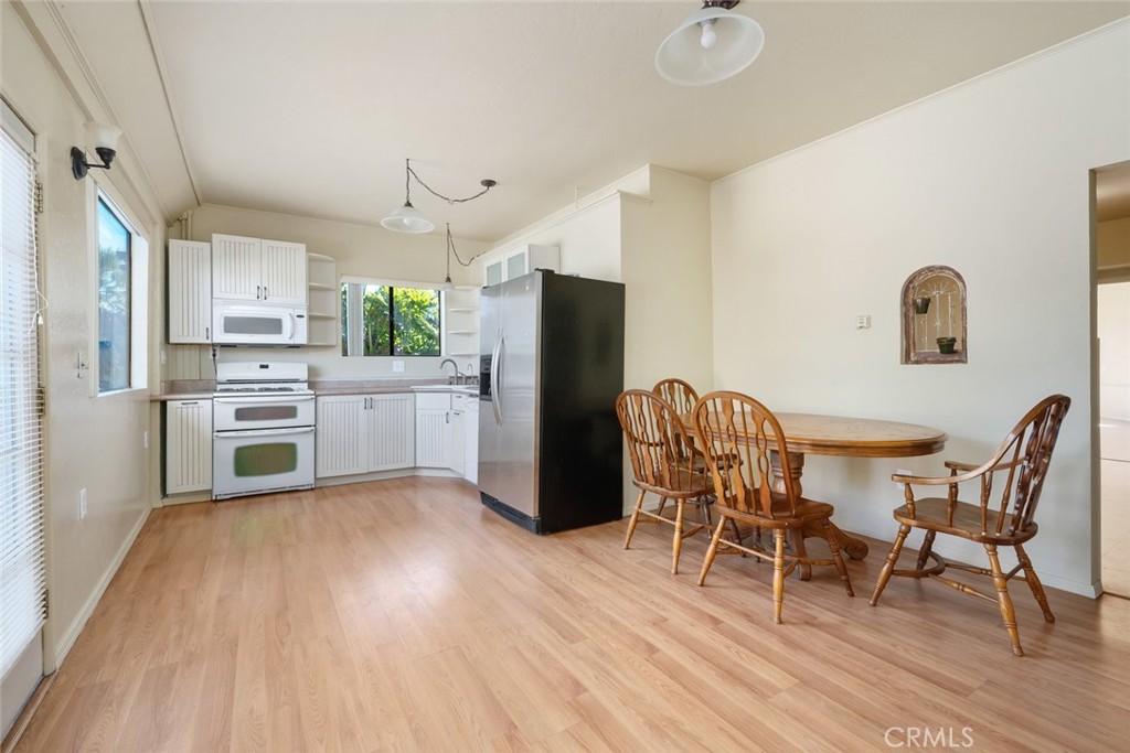 330 East Ormonde Road Arroyo Grande, CA 93420 - Photo 32 of 56 a kitchen with a table chairs refrigerator and microwave