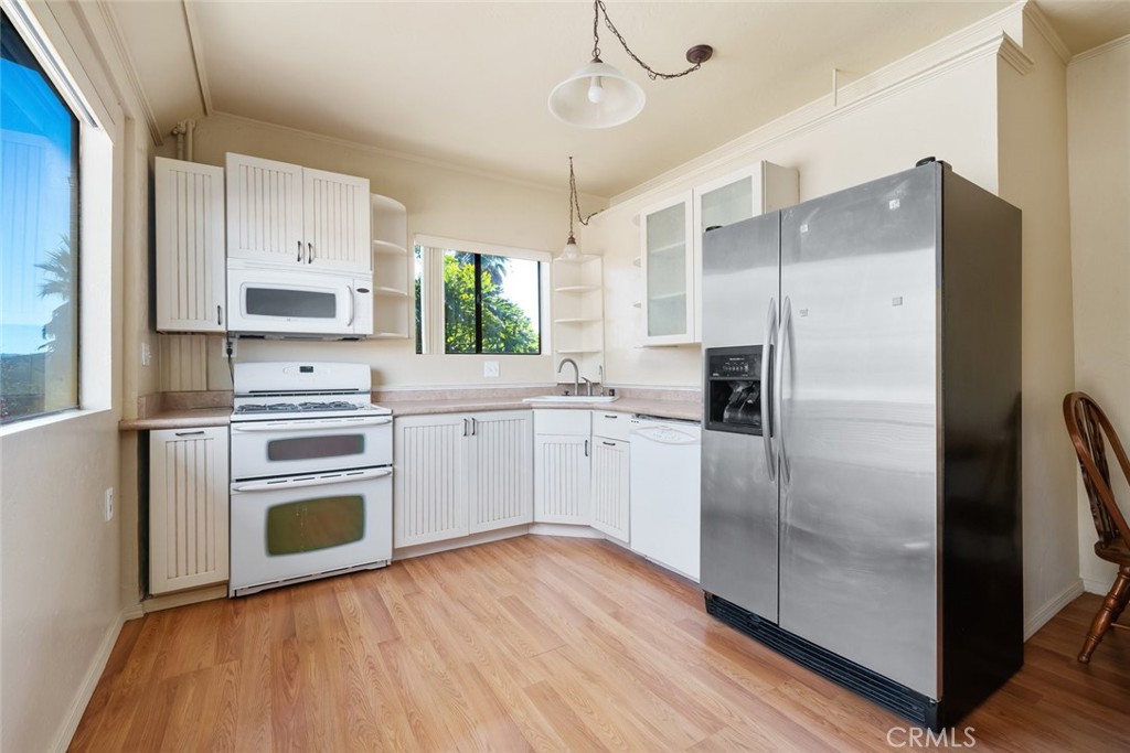 330 East Ormonde Road Arroyo Grande, CA 93420 - Photo 33 of 56 a kitchen with a refrigerator a sink and dishwasher a stove top oven with wooden floor