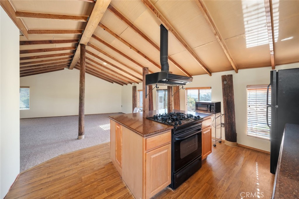 330 East Ormonde Road Arroyo Grande, CA 93420 - Photo 42 of 56 a kitchen with granite countertop a stove and a wooden floor