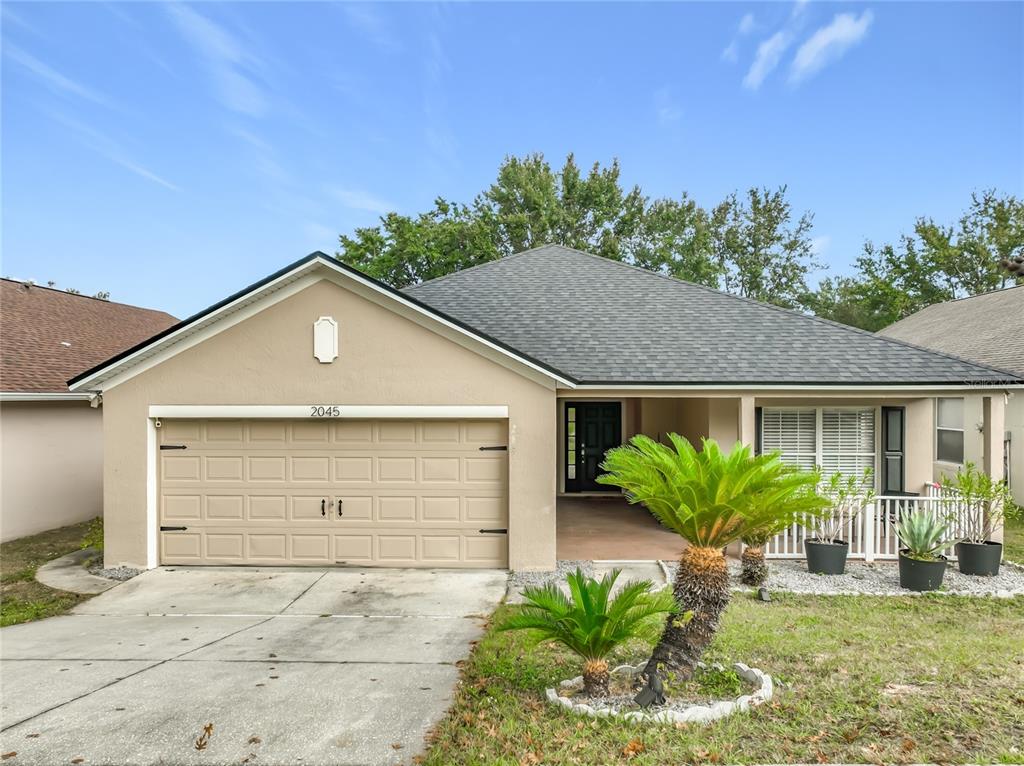 a front view of a house with a yard and garage