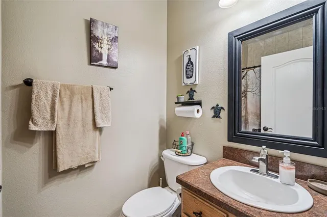 a bathroom with a sink toilet and mirror