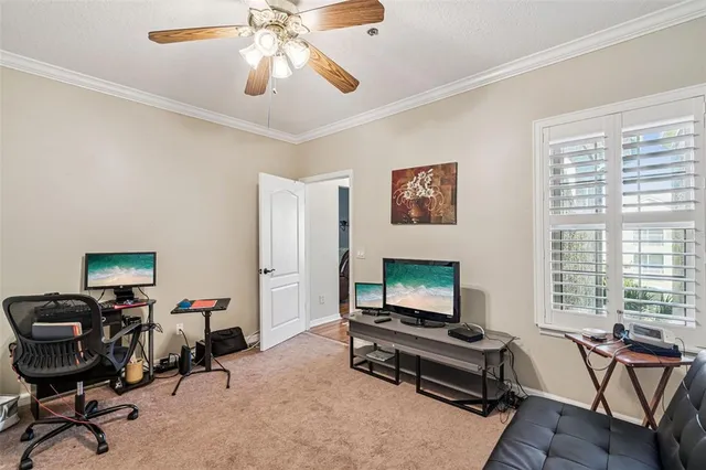 a living room with furniture a flat screen tv and a window