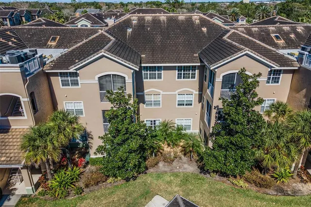an aerial view of a house with a yard and garage