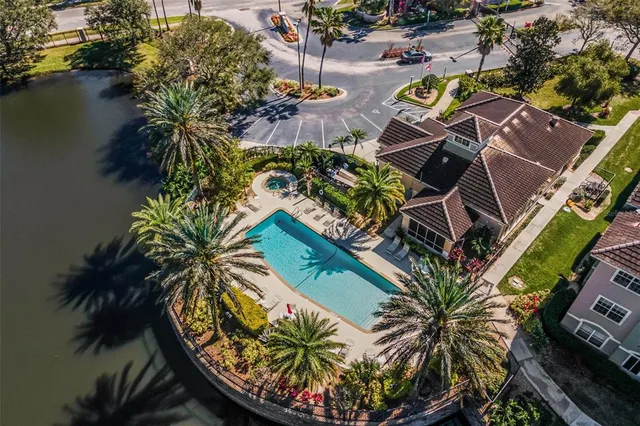 an aerial view of a house with garden space and swimming pool