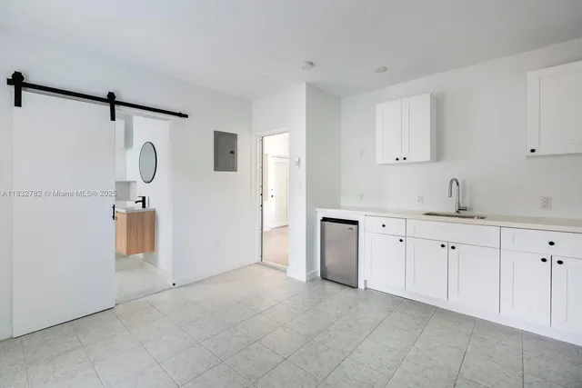 a spacious bathroom with a granite countertop sink mirror and cabinets