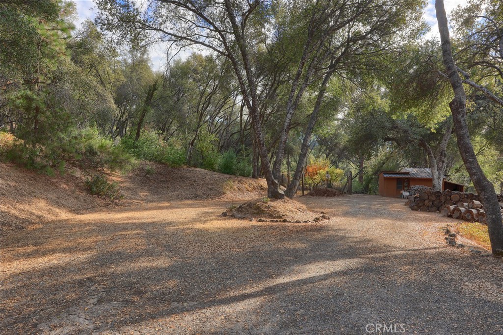 3692 Manzanita Road Mariposa, CA 95338 - Photo 59 of 71 a backyard of a house with trees and houses
