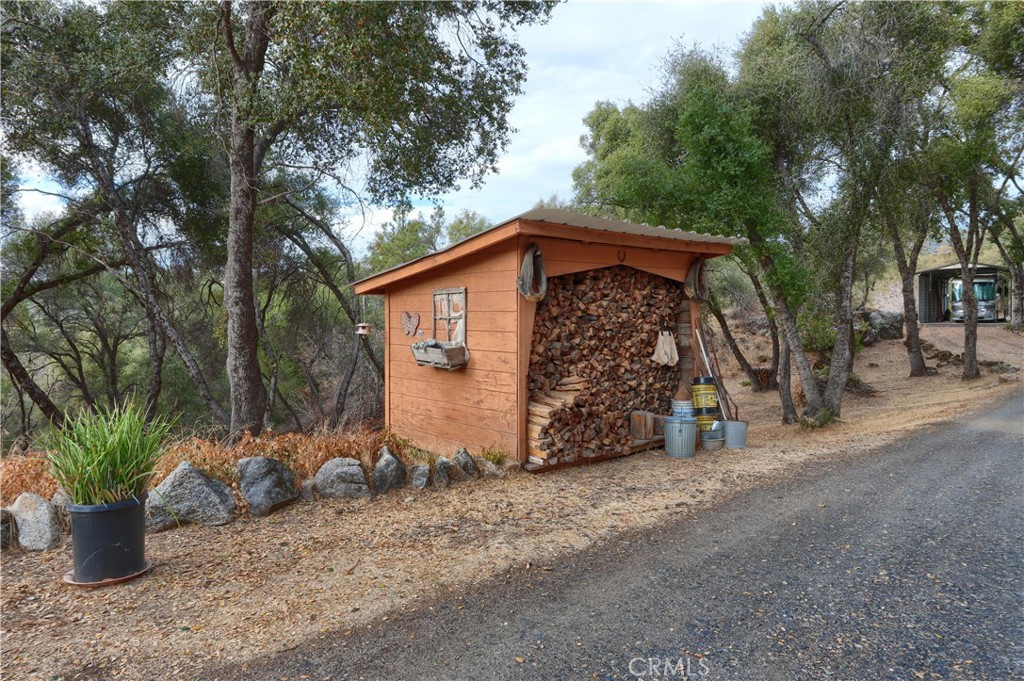 3692 Manzanita Road Mariposa, CA 95338 - Photo 63 of 71 a view of a wooden house with large trees