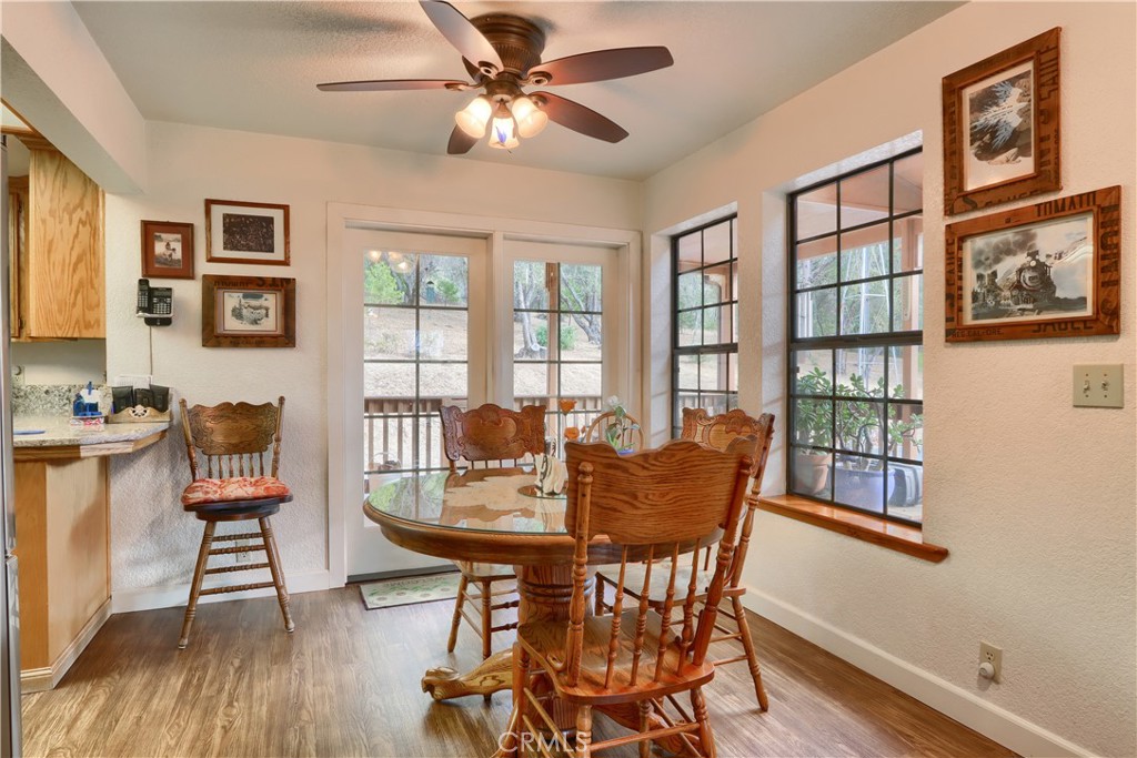 3692 Manzanita Road Mariposa, CA 95338 - Photo 9 of 71 a dining room with furniture a window and wooden floor