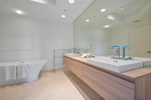 a spacious bathroom with a double vanity sink and a mirror