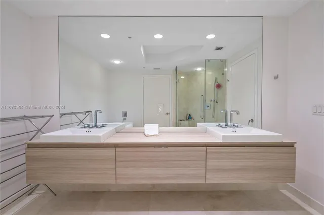 a bathroom with a sink double vanity and a mirror