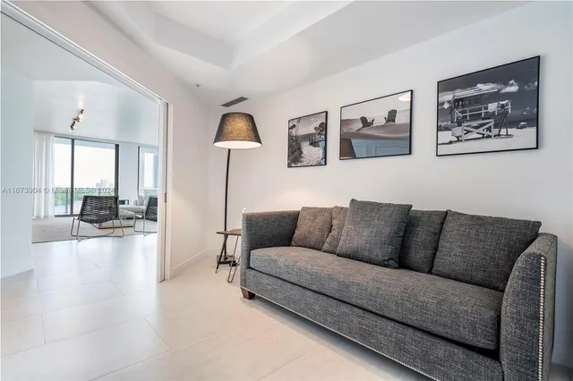 a living room with furniture and a large mirror