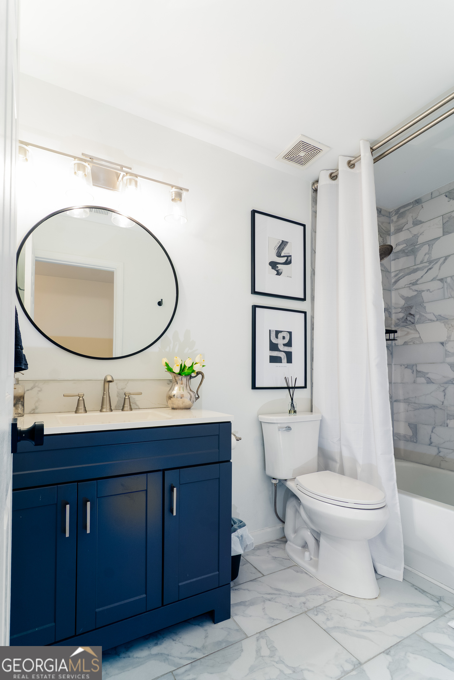 4957 Warmstone Way Southeast, Unit 15 Atlanta, GA 30339 - Photo 19 of 34 a bathroom with a toilet a sink and a mirror