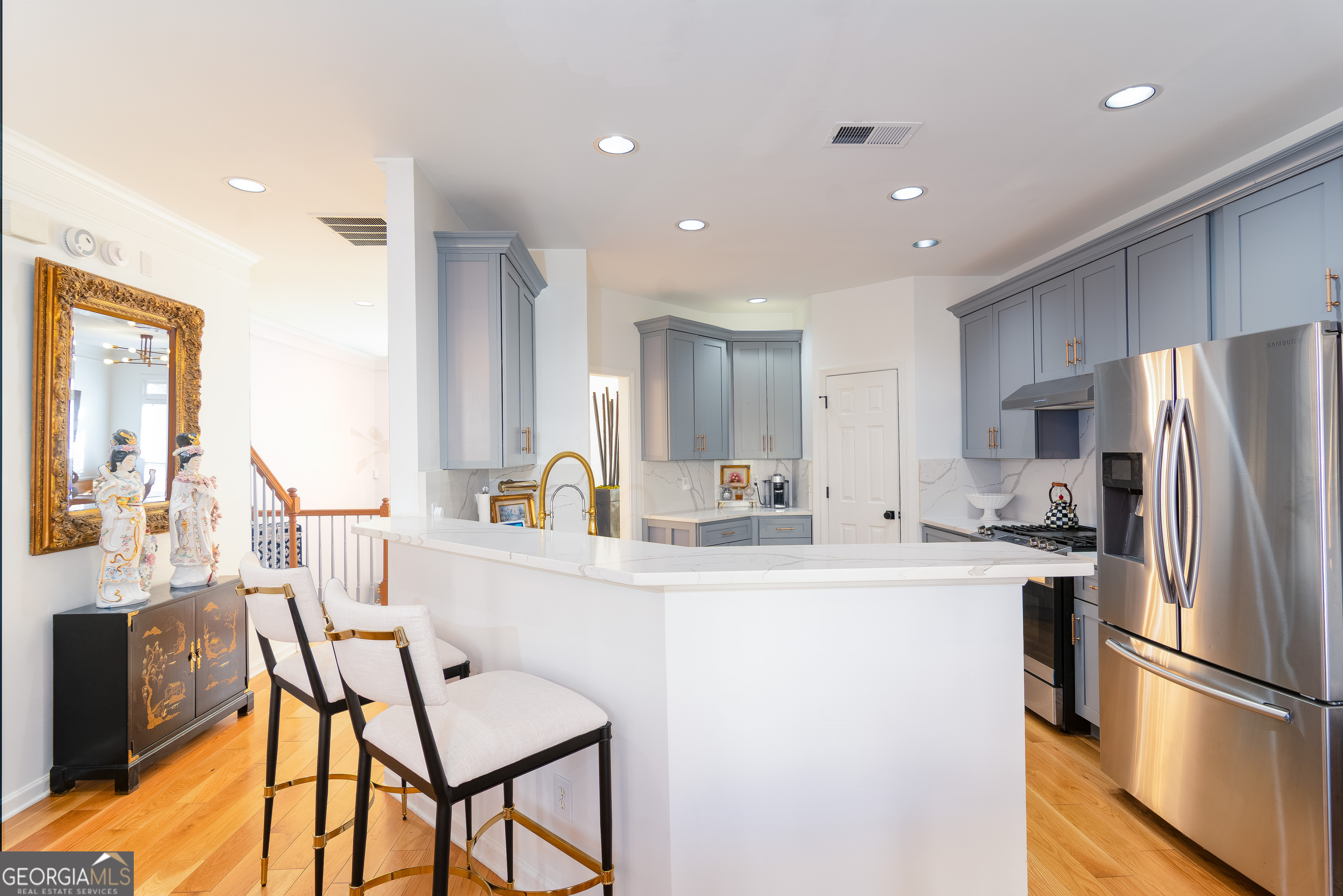 4957 Warmstone Way Southeast, Unit 15 Atlanta, GA 30339 - Photo 9 of 34 a kitchen with stainless steel appliances granite countertop a refrigerator a sink a stove a dining table and chairs
