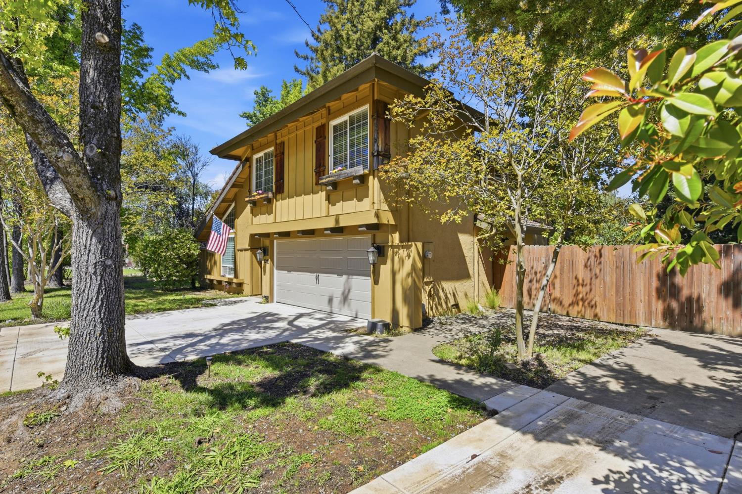 3283 Cambridge Road Cameron Park, CA 95682 - Photo 3 of 61 a view of a yard in front of a house with a large tree