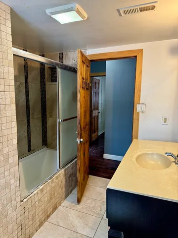 a bathroom with a tub and shower