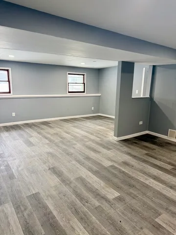 a view of wooden floor and windows in a room