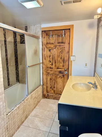 a bathroom with a tub and a sink