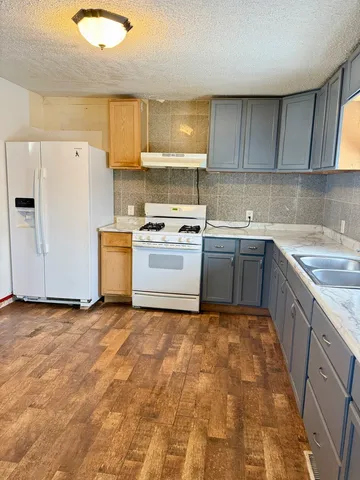 a kitchen with a sink stove and cabinets