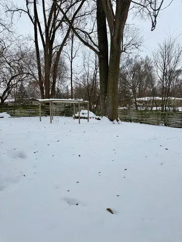 a view of house with a yard