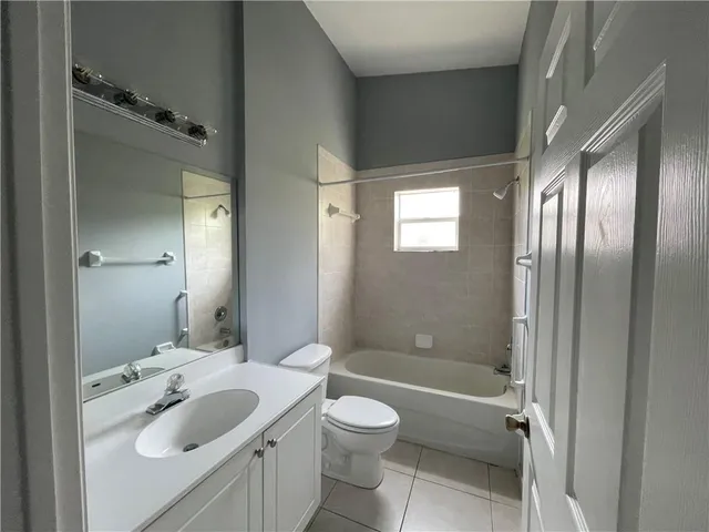 a bathroom with a sink toilet tub and shower