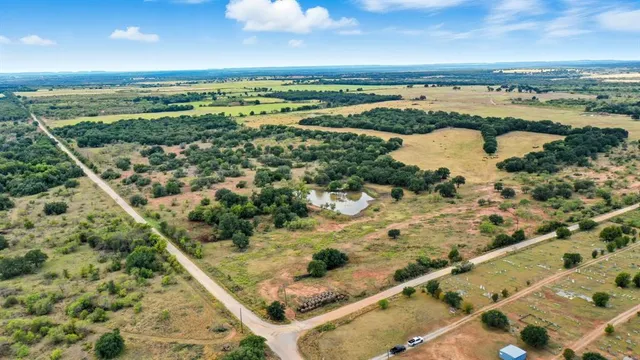 an aerial view of a city with lots of residential buildings and mountain view in back
