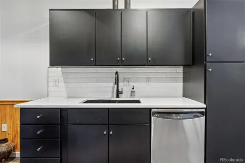 a kitchen with a sink and cabinets