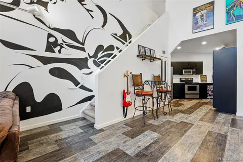 a view of entryway kitchen and hall with wooden floor