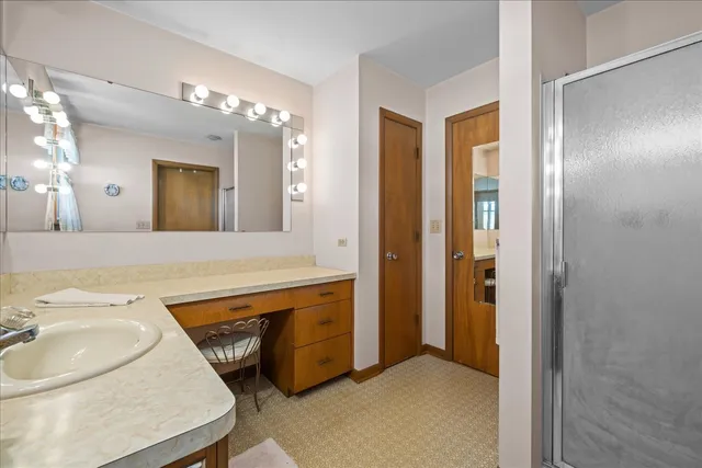 a bedroom with a bed and a dresser in it