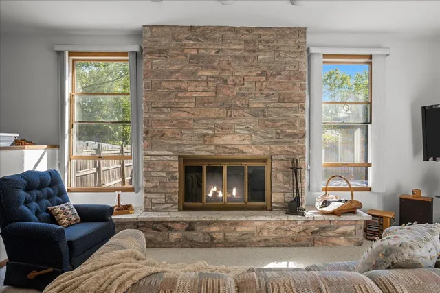 a living room with furniture a fireplace and a flat screen tv