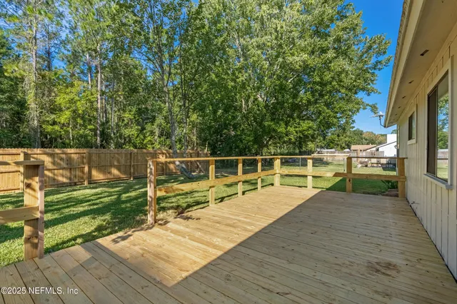 a view of a wooden deck with a yard