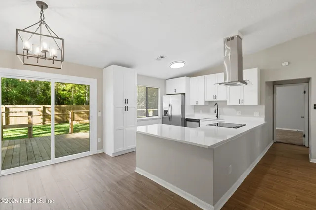 a large white kitchen with a large window