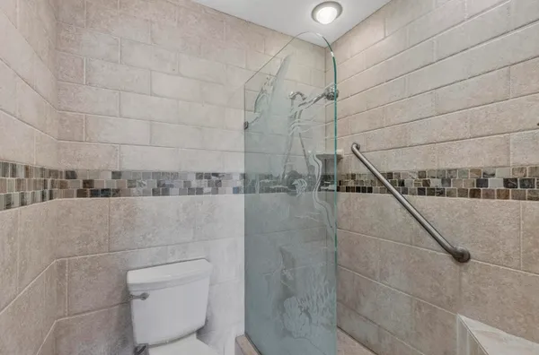 a bathroom with a toilet and shower