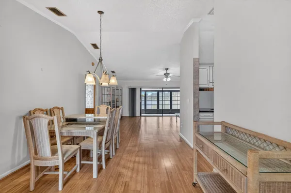 a view of a dining room with furniture wooden floor and chandelier