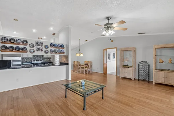 a living room with furniture and kitchen view
