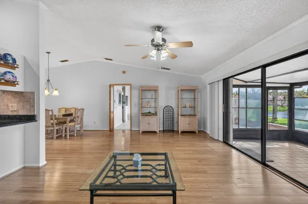 a living room with furniture a flat screen tv and a table