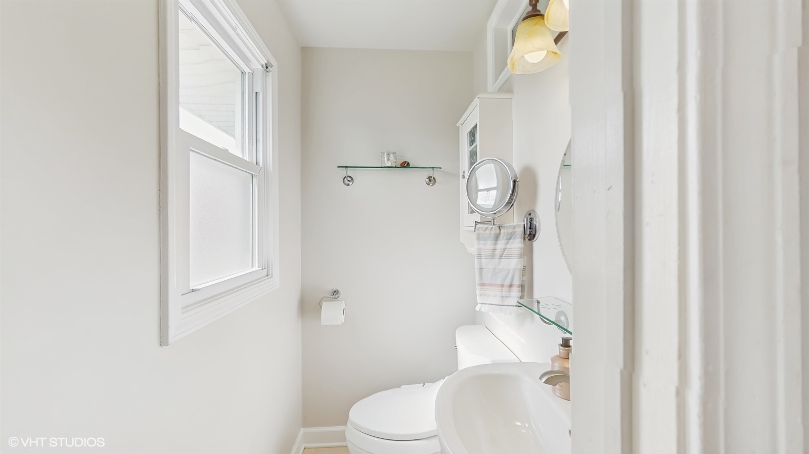 6040 Puffer Road Downers Grove, IL 60516 - Photo 17 of 29 a white toilet sitting next to a bathroom sink