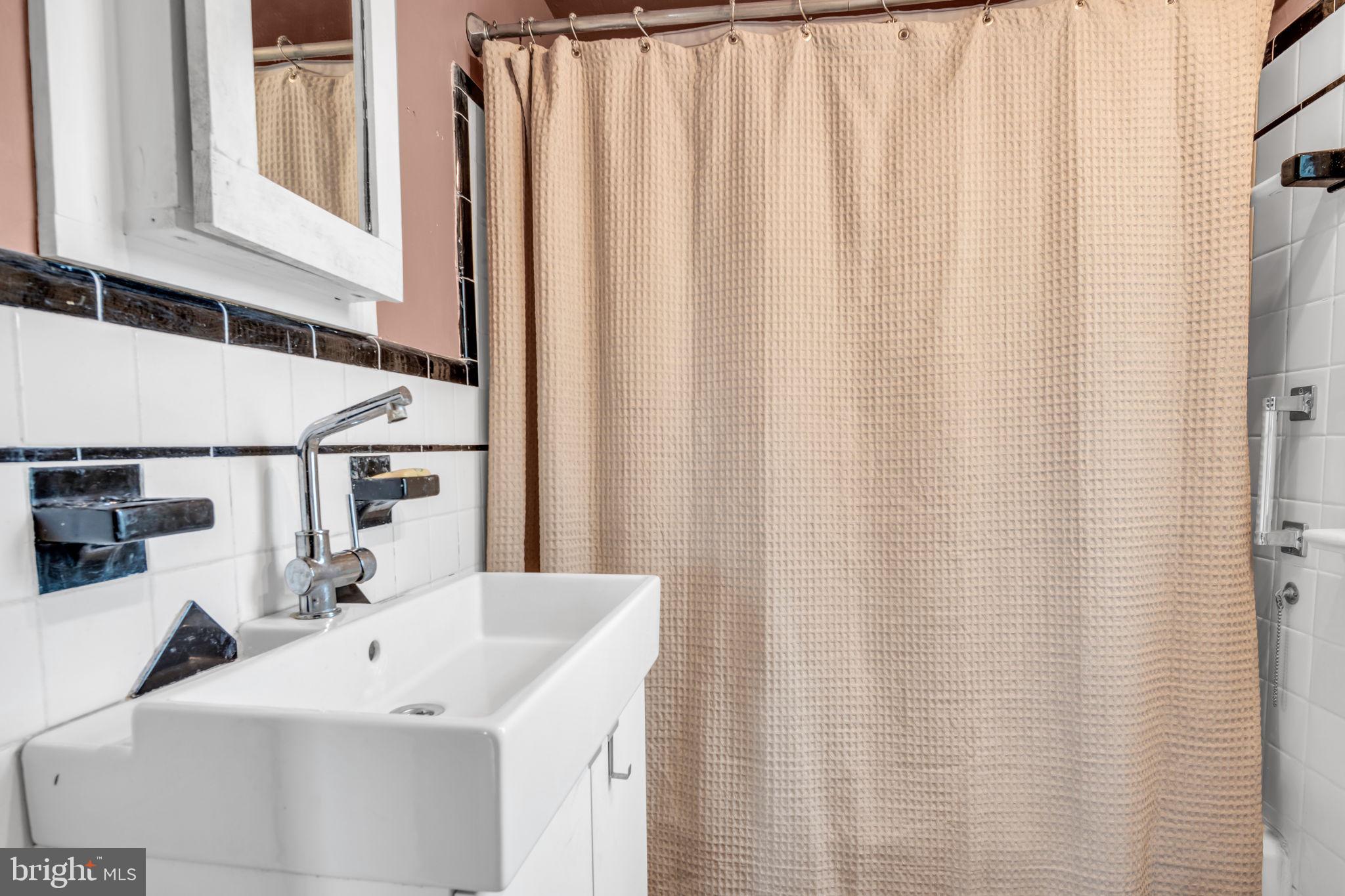 916 North Spring Street Middletown, PA 17057 - Photo 20 of 32 a bathroom with a sink and a mirror