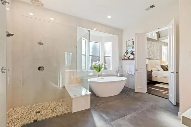a bathroom with a tub sink and mirror