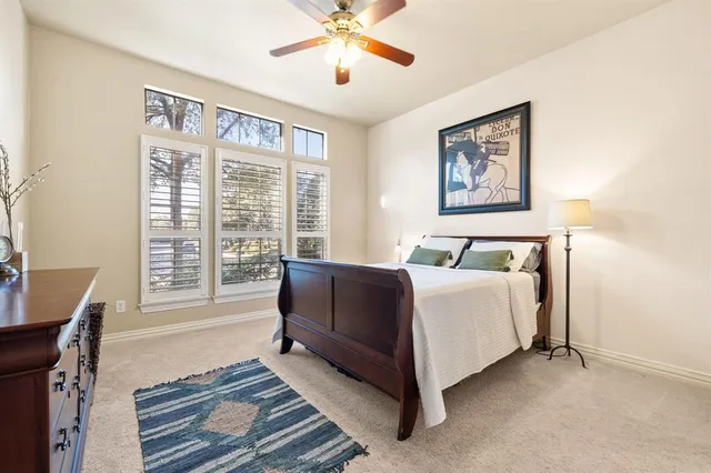 a spacious bedroom with a bed and a large window