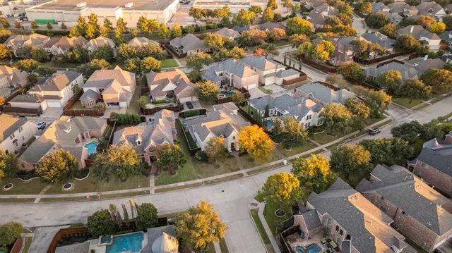 an aerial view of residential houses with outdoor space