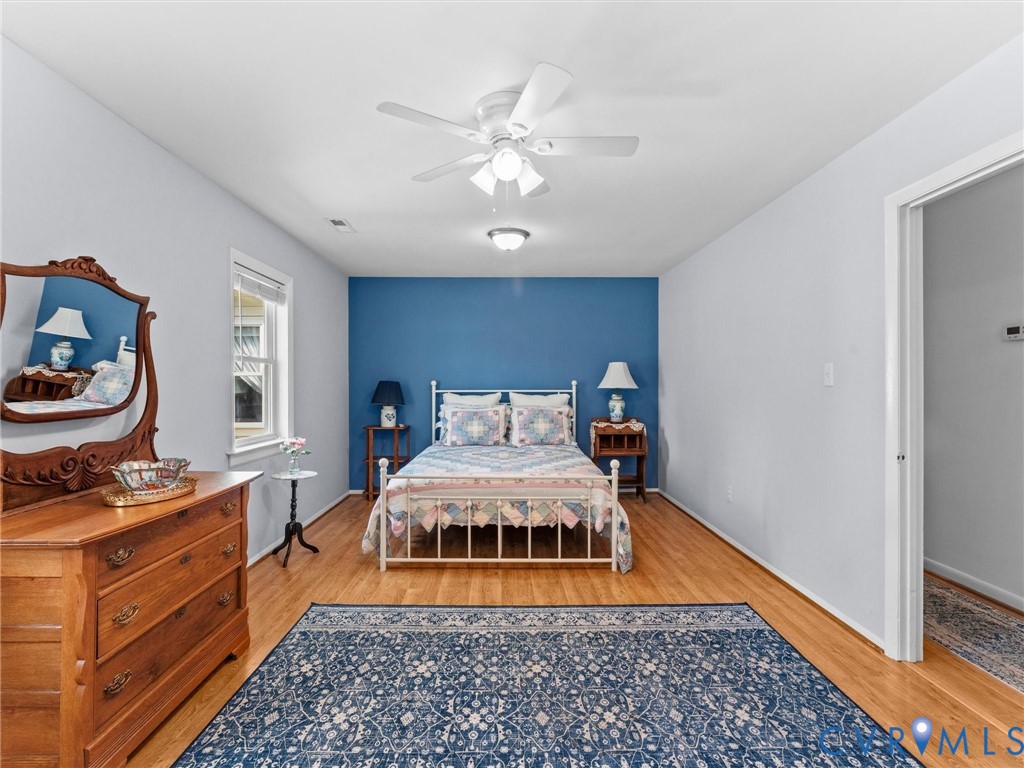10488 Old Telegraph Road Ashland, VA 23005 - Photo 53 of 69 a bedroom with a bed and wooden floor