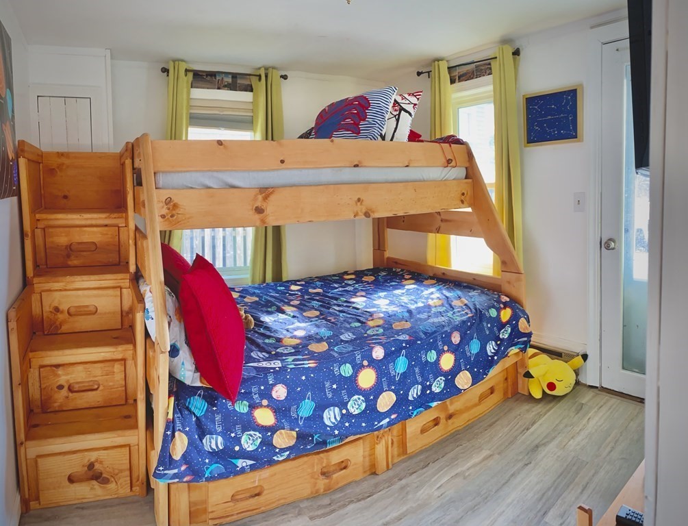 206 A Phillips Road Sandwich, MA 02563 - Photo 9 of 25 a bed sitting in a bedroom next to a window