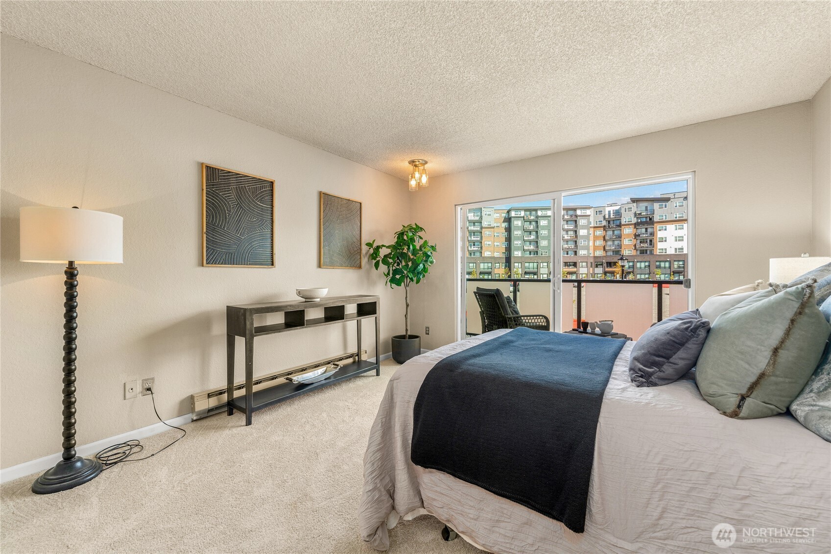 1175 Harrington Place Northeast, Unit 205 Renton, WA 98056 - Photo 12 of 30 a living room with a bed furniture and a large window
