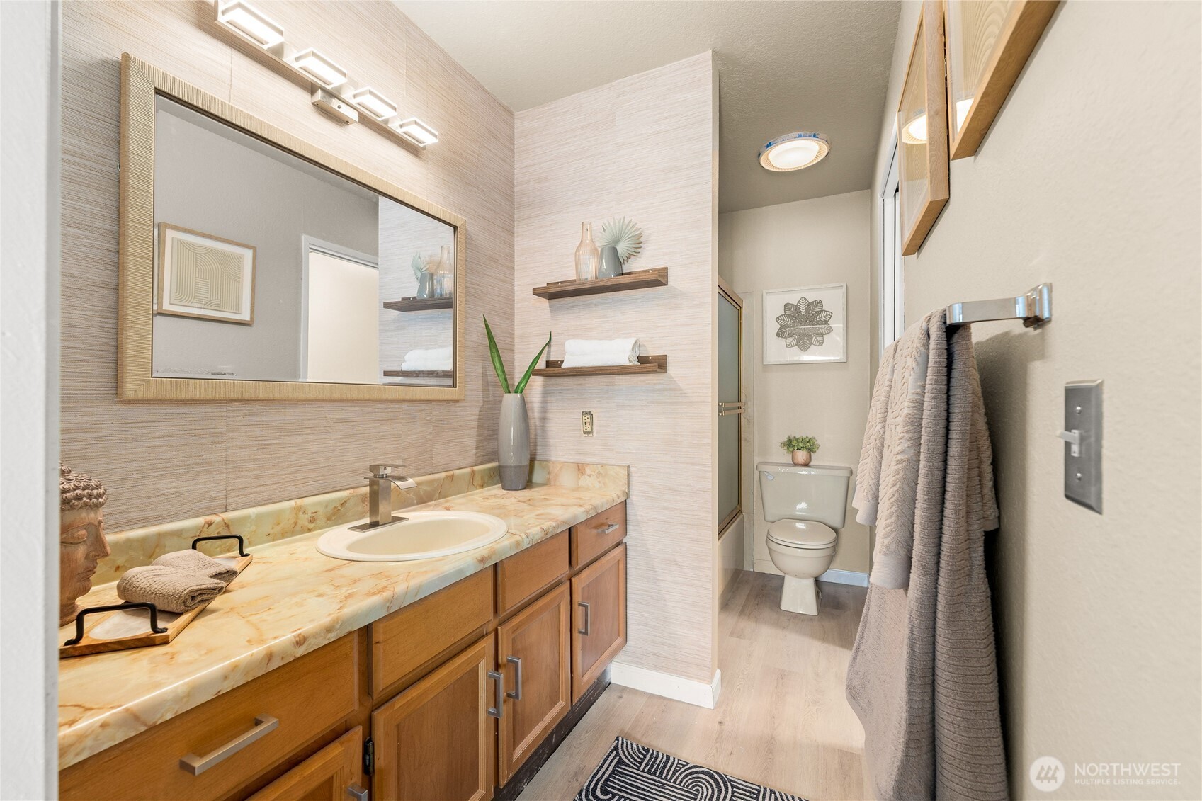 1175 Harrington Place Northeast, Unit 205 Renton, WA 98056 - Photo 15 of 30 a spacious bathroom with a granite countertop sink and a mirror
