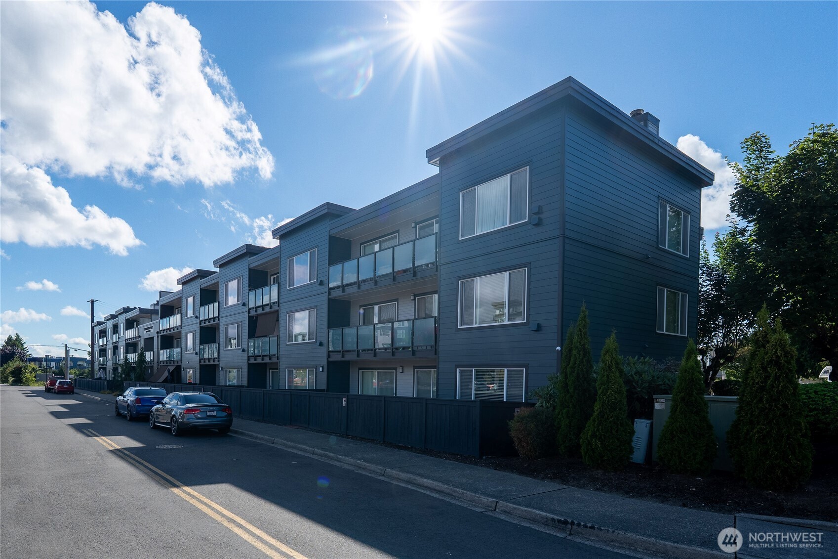 1175 Harrington Place Northeast, Unit 205 Renton, WA 98056 - Photo 23 of 30 a couple of cars parked in front of brick building
