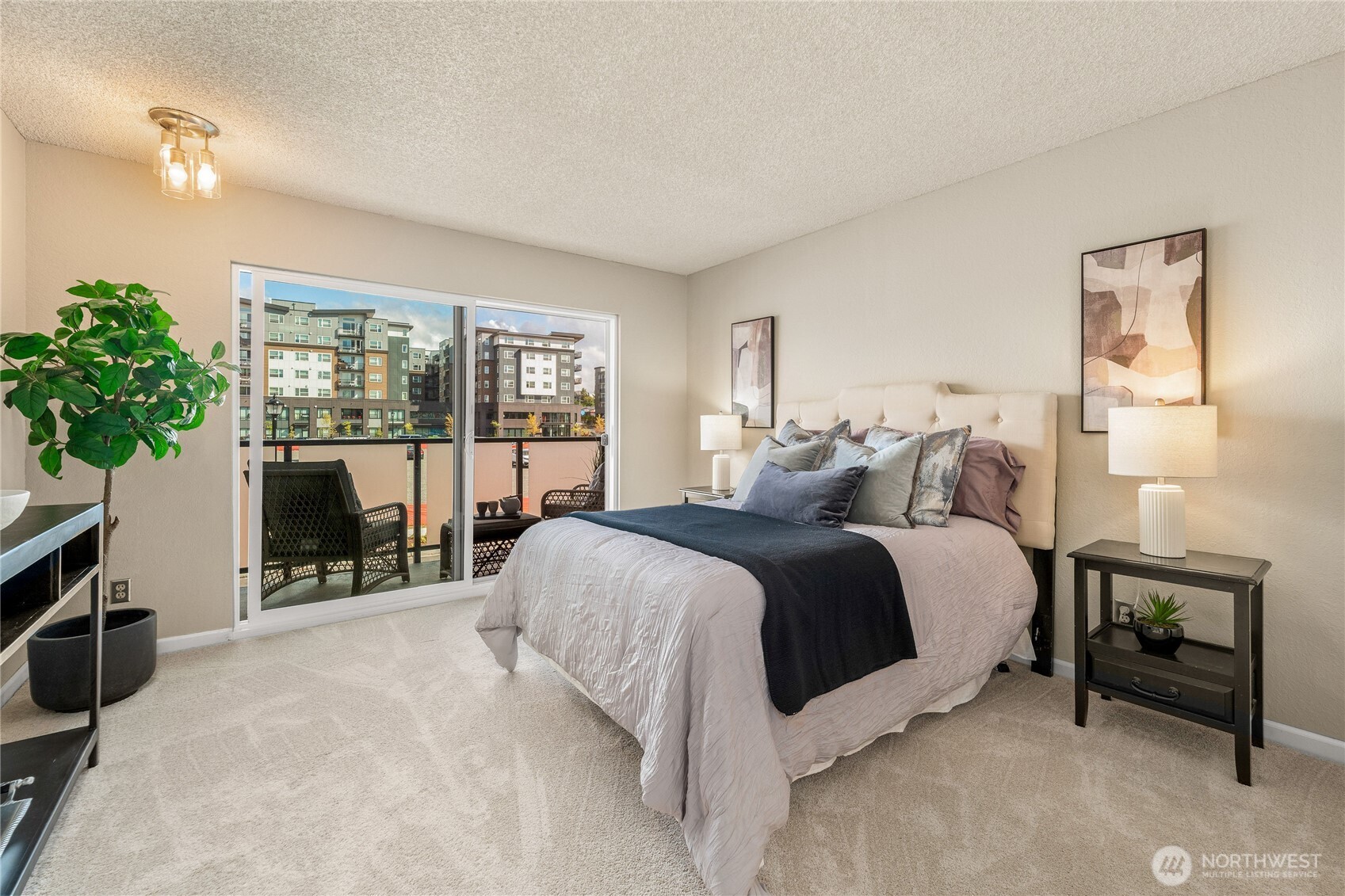 1175 Harrington Place Northeast, Unit 205 Renton, WA 98056 - Photo 10 of 30 a spacious bedroom with a bed and a fireplace with window
