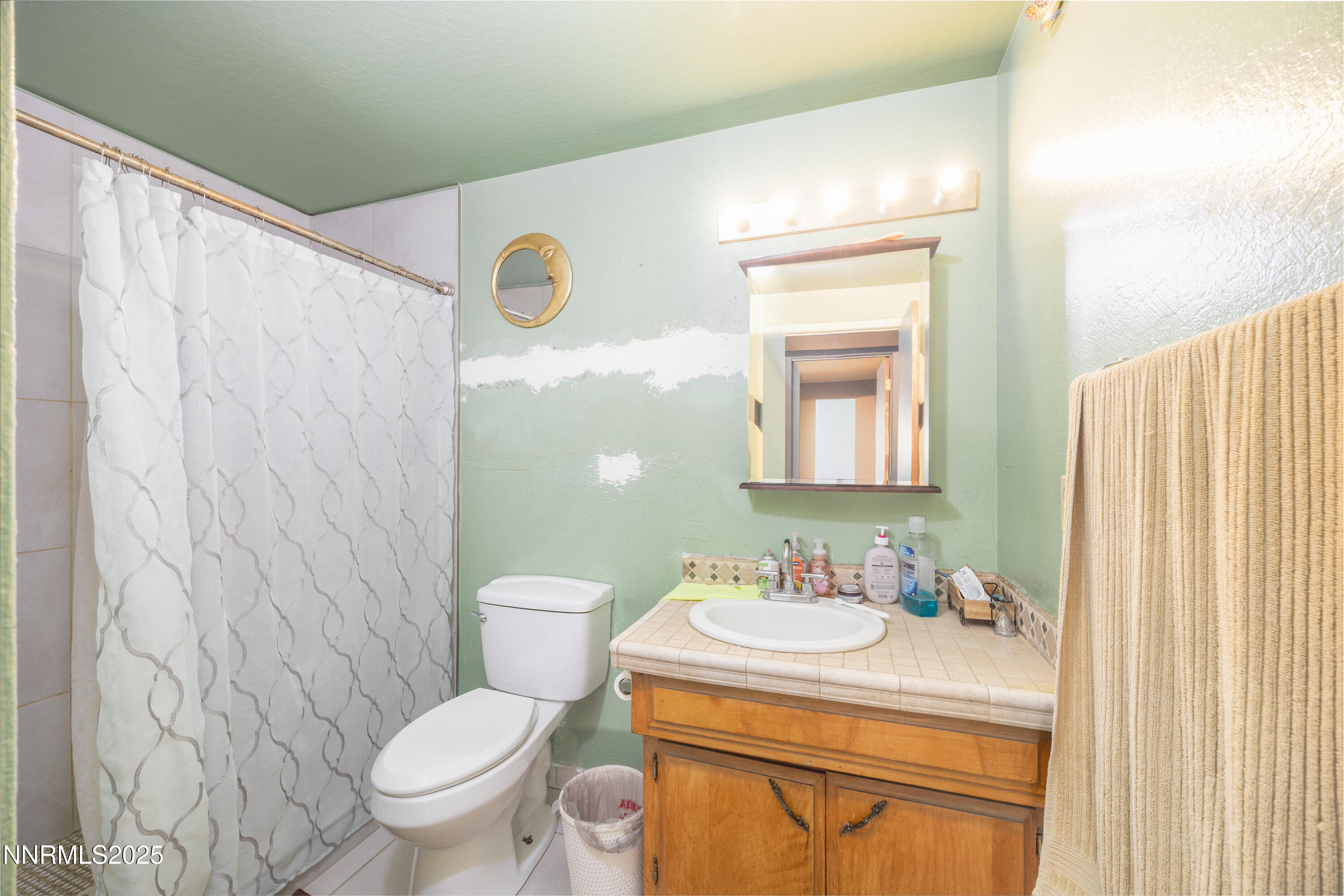 11605 Lemmon Drive Reno, NV 89506 - Photo 11 of 18 a bathroom with a granite countertop sink toilet and a mirror