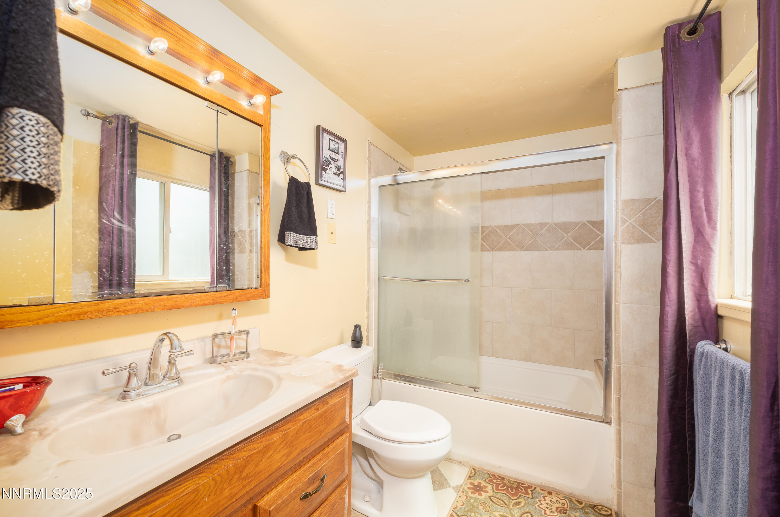 11605 Lemmon Drive Reno, NV 89506 - Photo 8 of 18 a bathroom with a sink toilet and shower